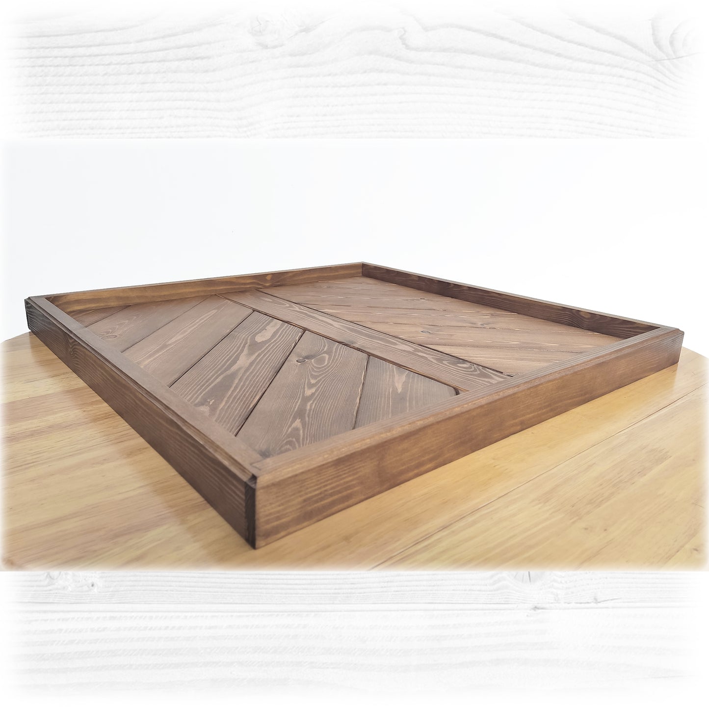 A solid wooden ottoman tray finished in an oak stain and lacquer on a wooden table with a white background