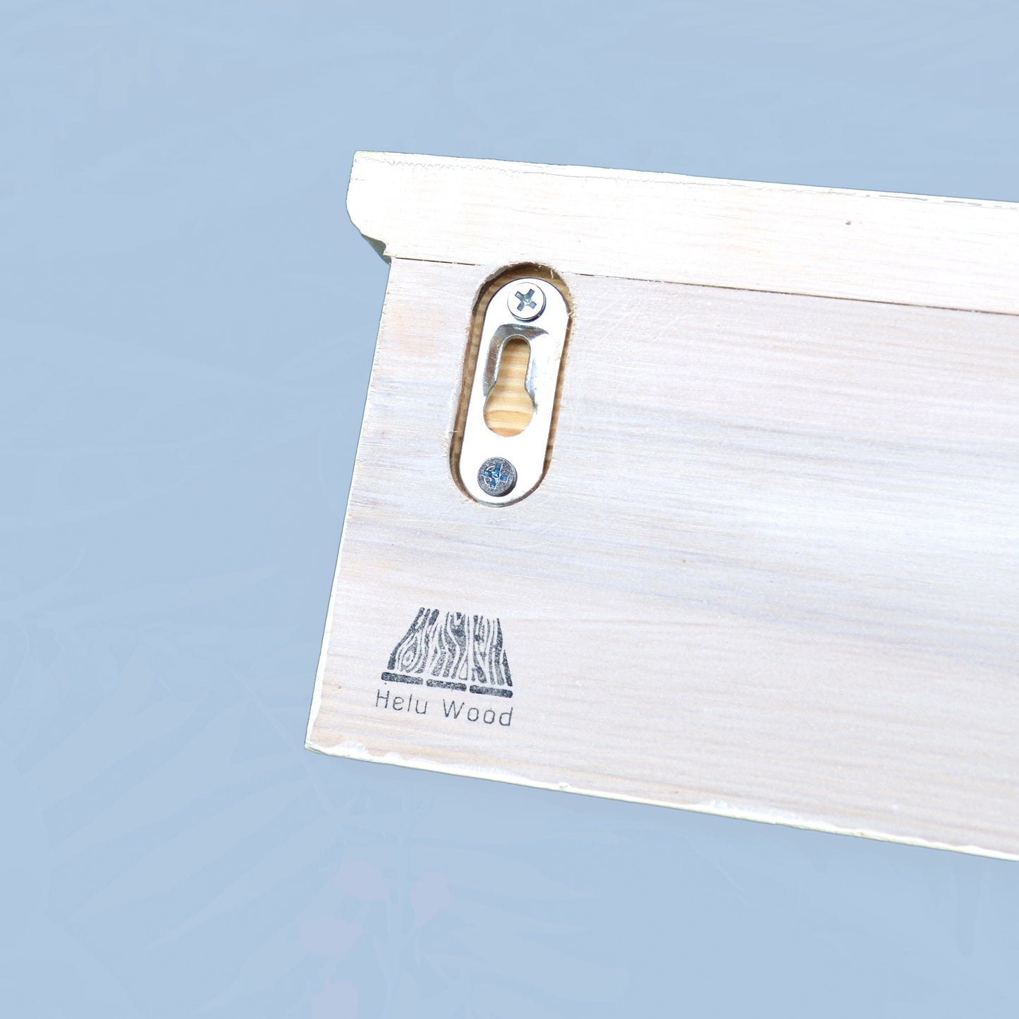 Back of a coat rack with a hidden fixing showing on the back and helu wood branding