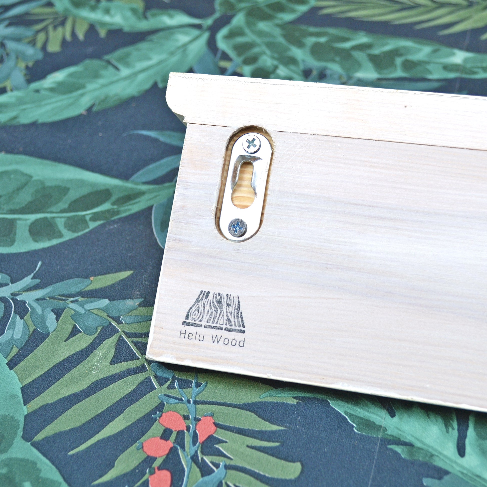 Back of a coat rack showing hidden fixings and helu wood branding