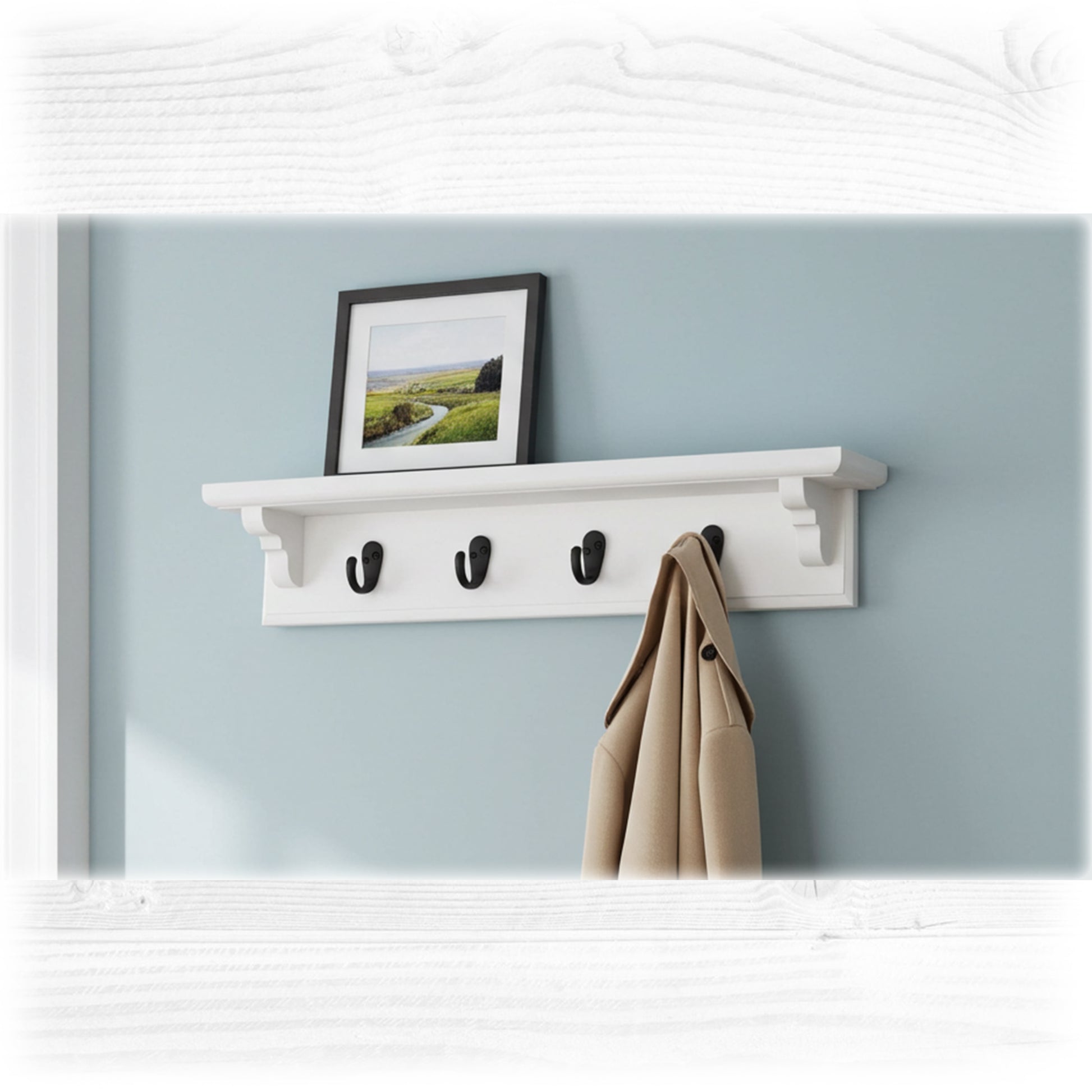 White wall shelf with hooks against a light blue wall, featuring a framed picture and a coat.