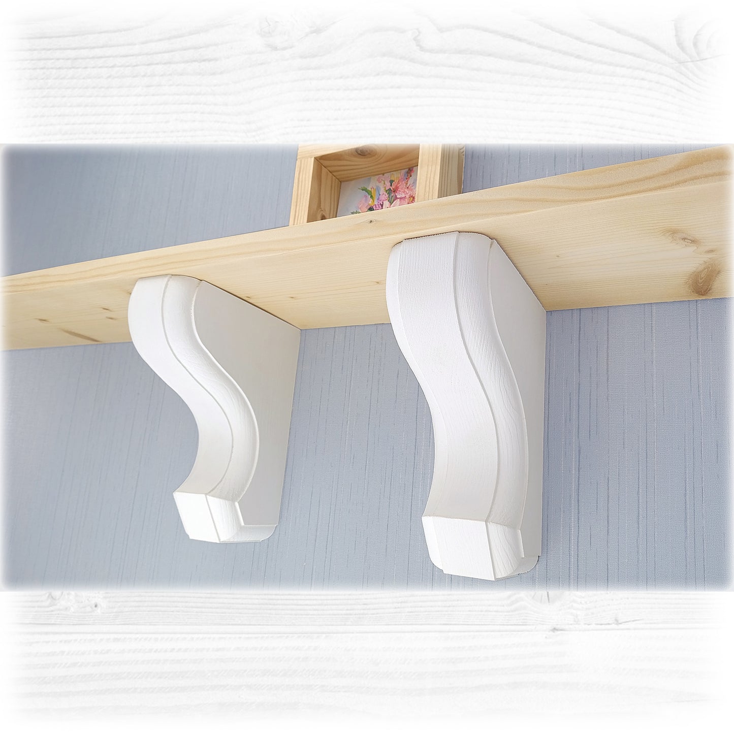 White wall-mounted wooden corbels with a wooden shelf above it on a light blue wall.