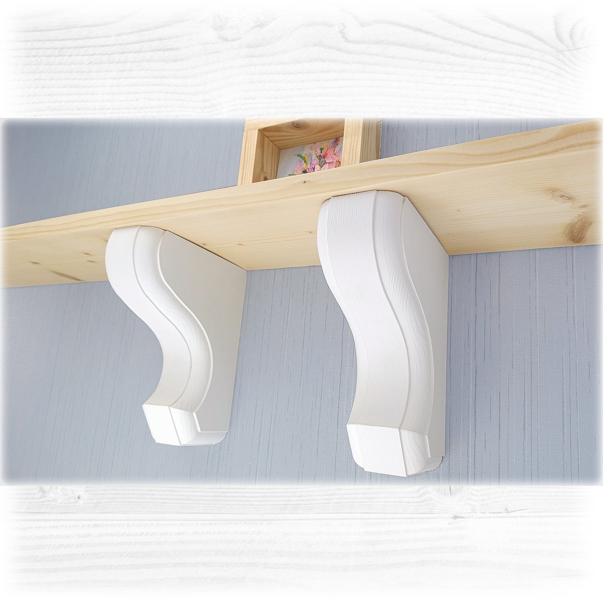 White wall-mounted wooden corbels with a wooden shelf above it on a light blue wall.