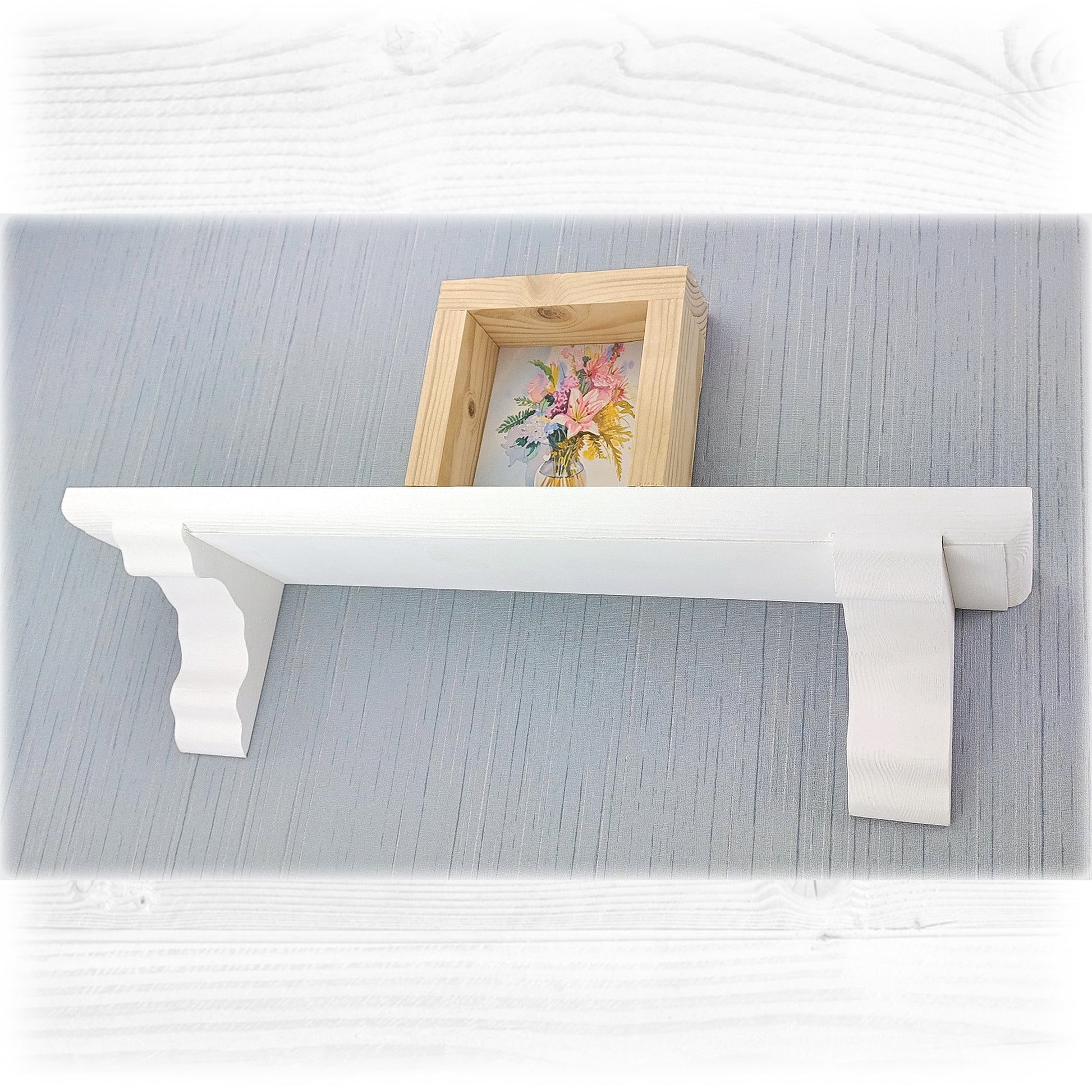 White decorative shelf with a wooden frame on a textured gray surface