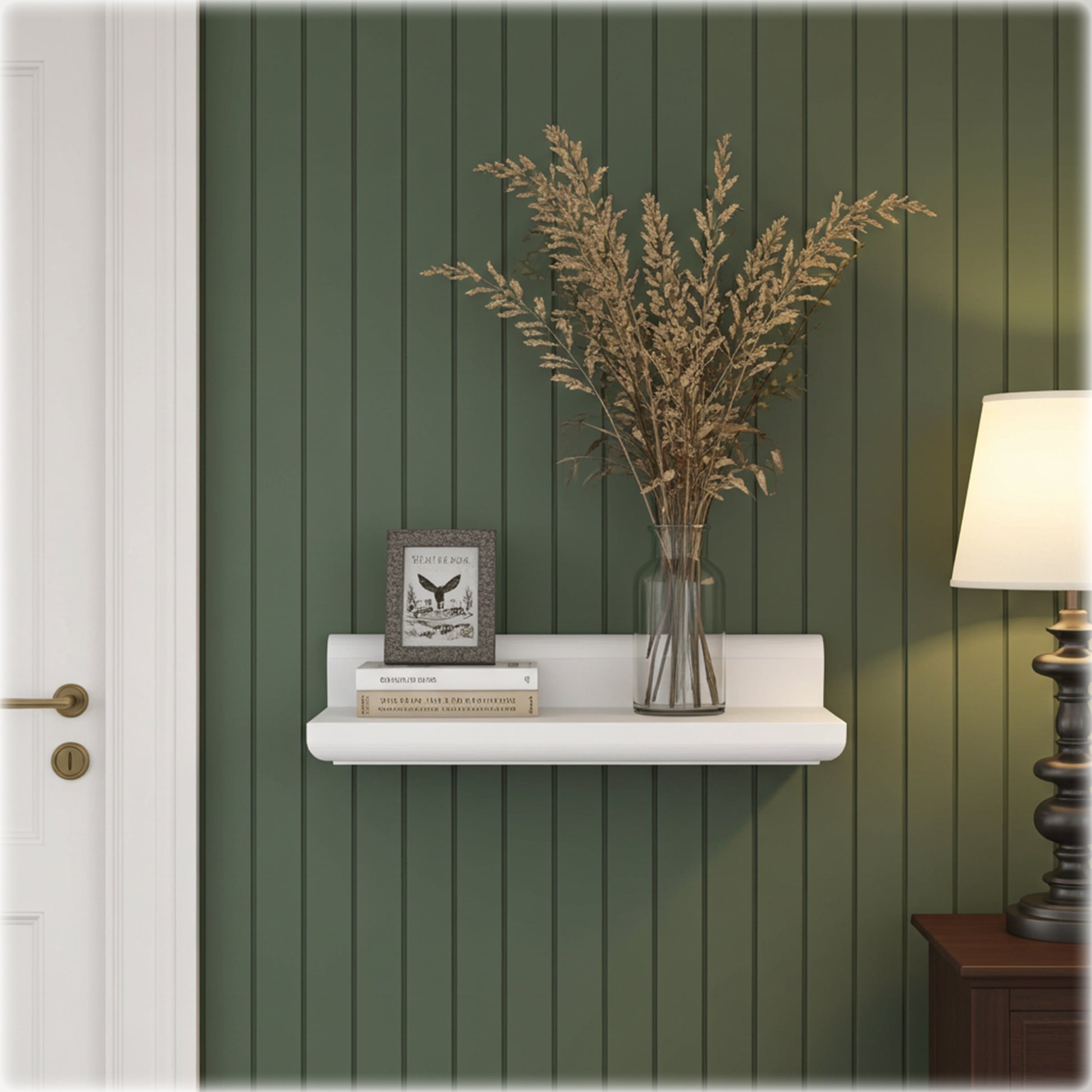 White shelf with decorative items against a green paneled wall