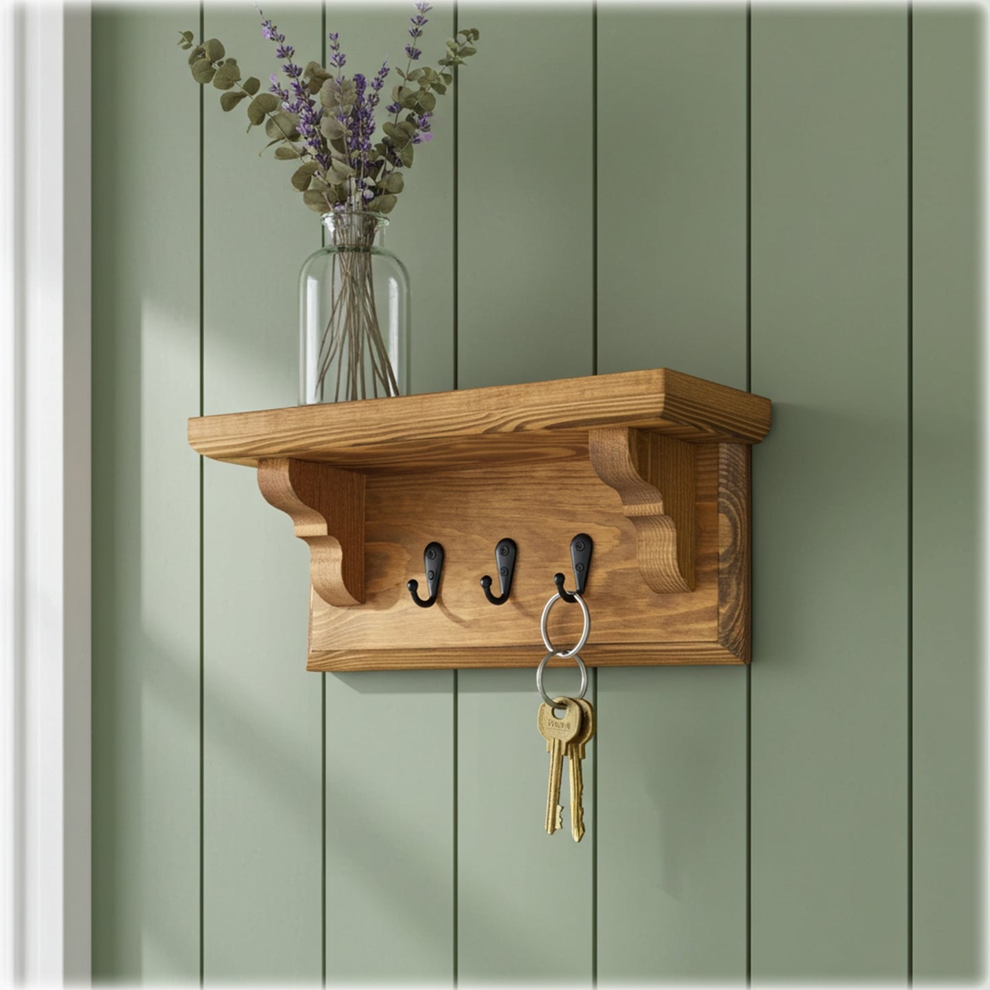 Wooden wall shelf with hooks and a vase of flowers on a green wooden panel background