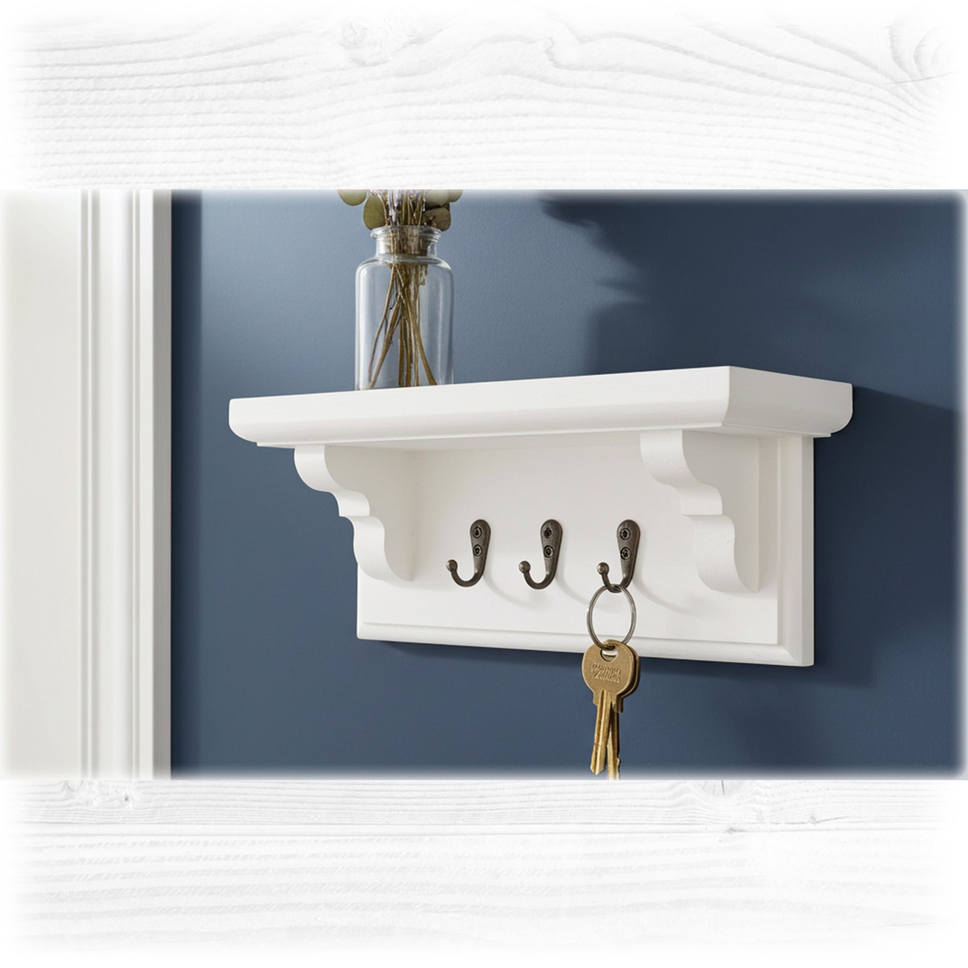 White wall shelf with hooks against a blue wall