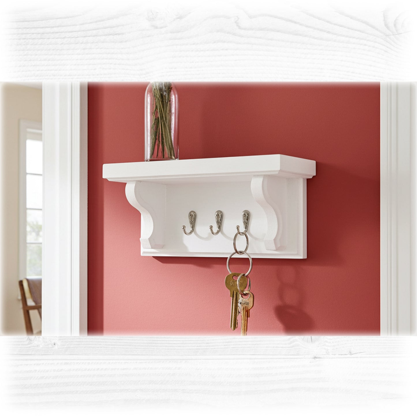 White wall shelf with hooks against a red wall