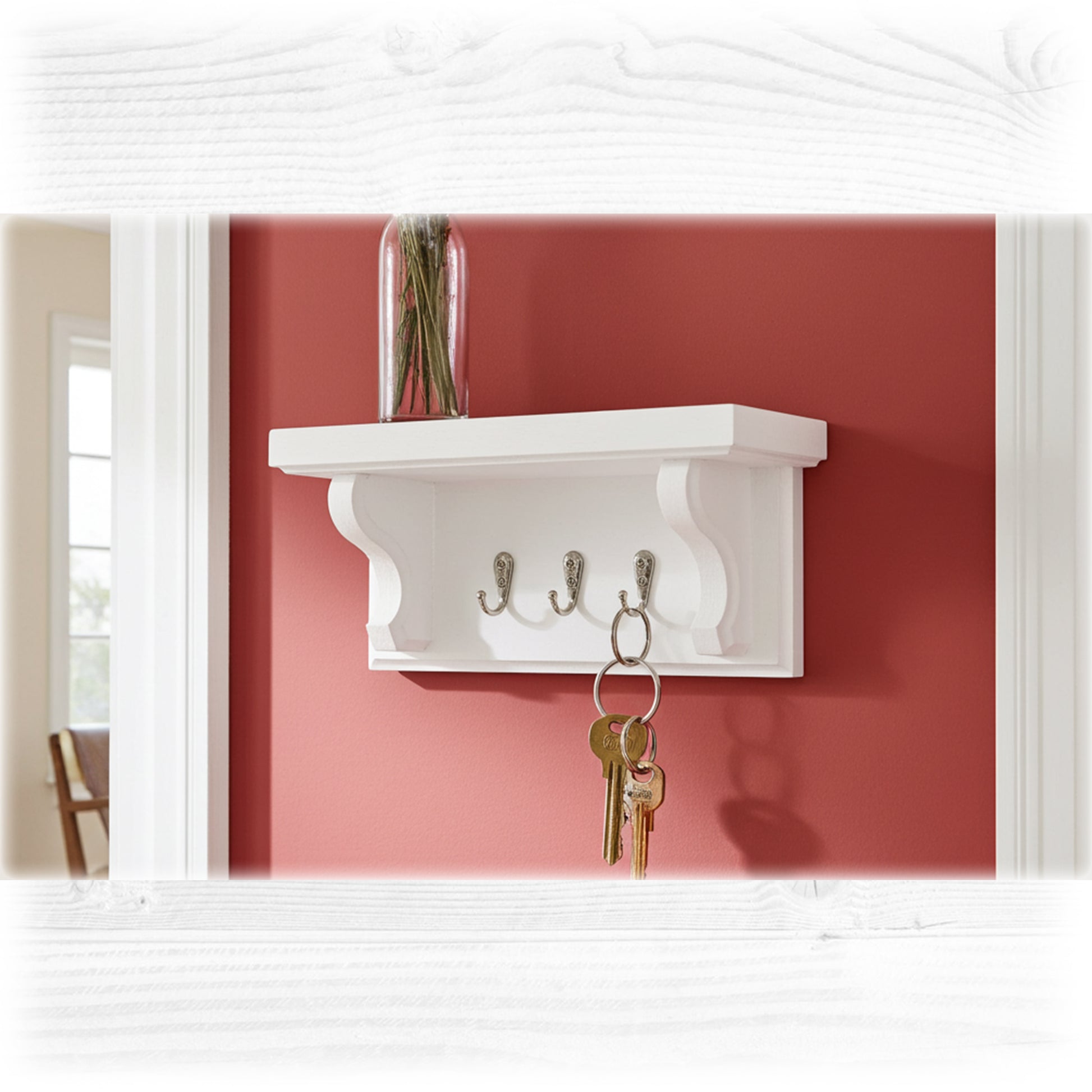 White wall shelf with hooks against a red wall