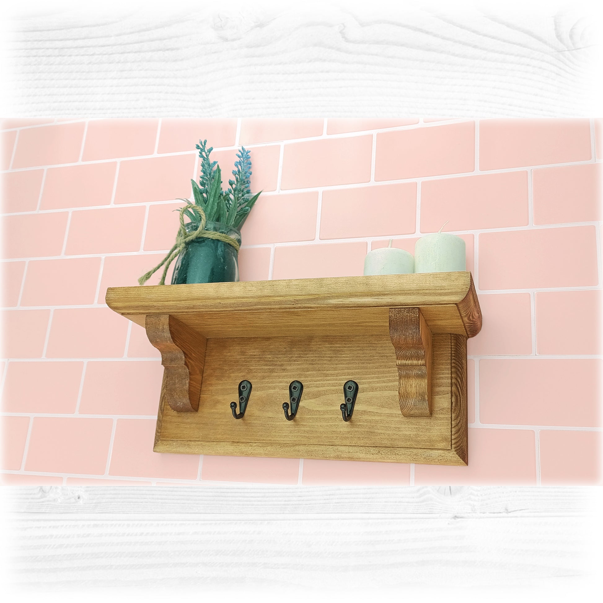 Wooden key rack with shelf against a pink tiled wall