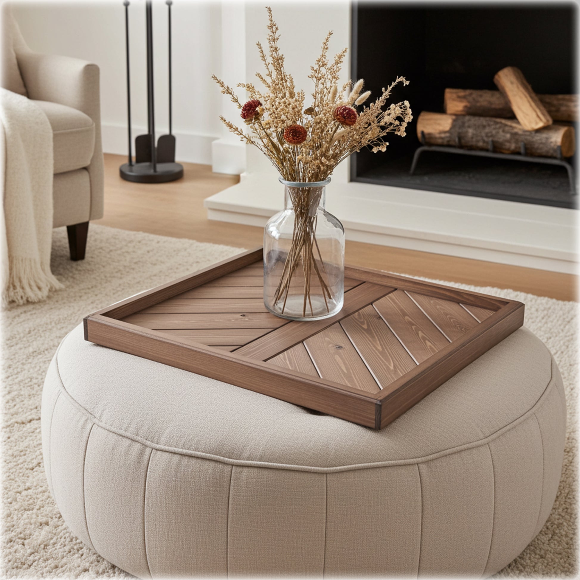 Wooden tray on a ottoman with a vase of flowers in a living room setting.