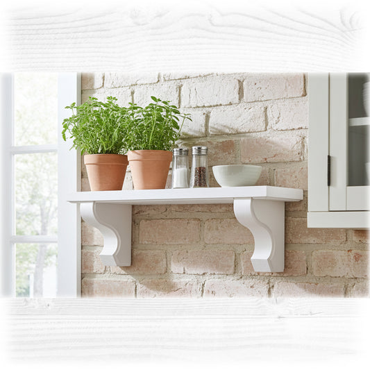 A white wooden shelf on a light brick wall with herb pots and spices on the shelf